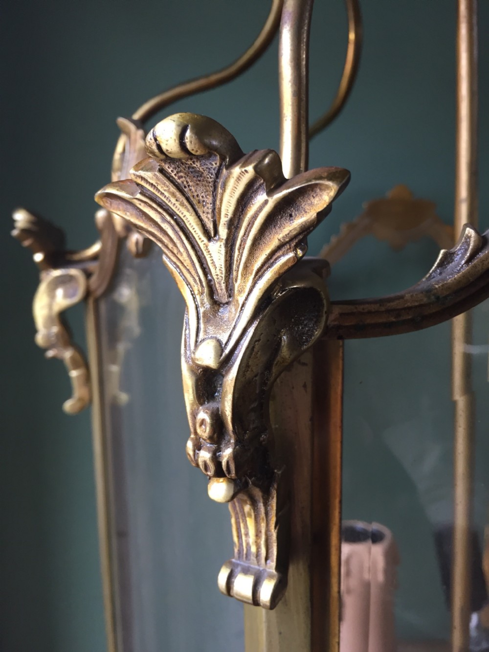 A late nineteenth-century French gilded brass hexagonal hall lantern featuring curved glass panels and acanthus leaf ornamentation. View IV