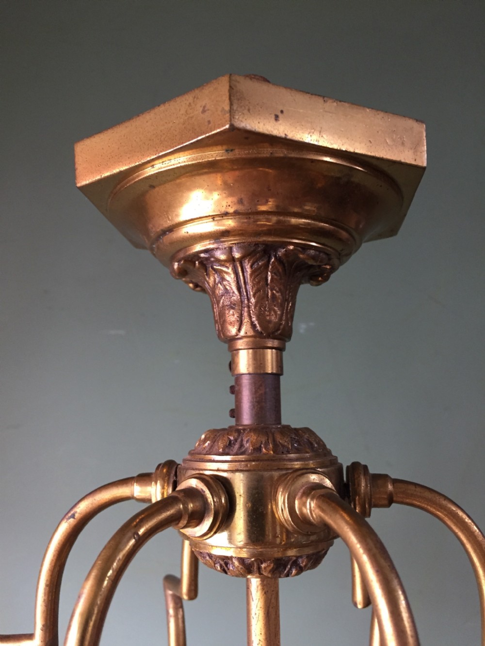 A late nineteenth-century French gilded brass hexagonal hall lantern featuring curved glass panels and acanthus leaf ornamentation. View V
