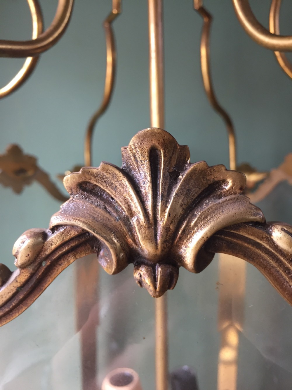 A late nineteenth-century French gilded brass hexagonal hall lantern featuring curved glass panels and acanthus leaf ornamentation. View VI