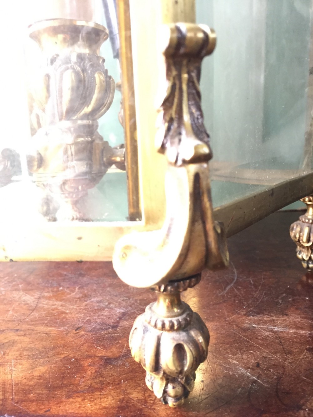A late nineteenth-century French gilded brass hexagonal hall lantern featuring curved glass panels and acanthus leaf ornamentation. View VII