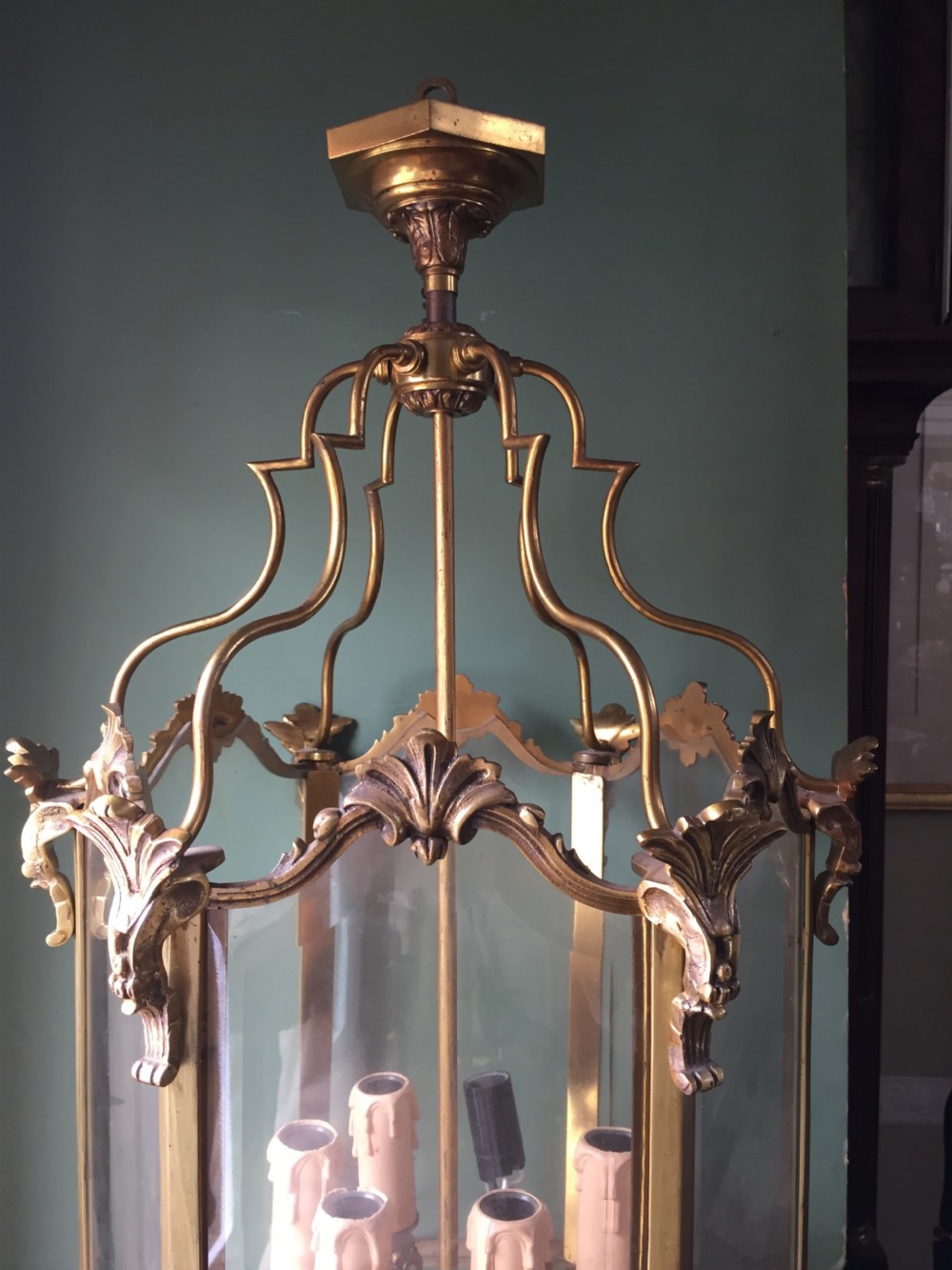 A late nineteenth-century French gilded brass hexagonal hall lantern featuring curved glass panels and acanthus leaf ornamentation. View XII