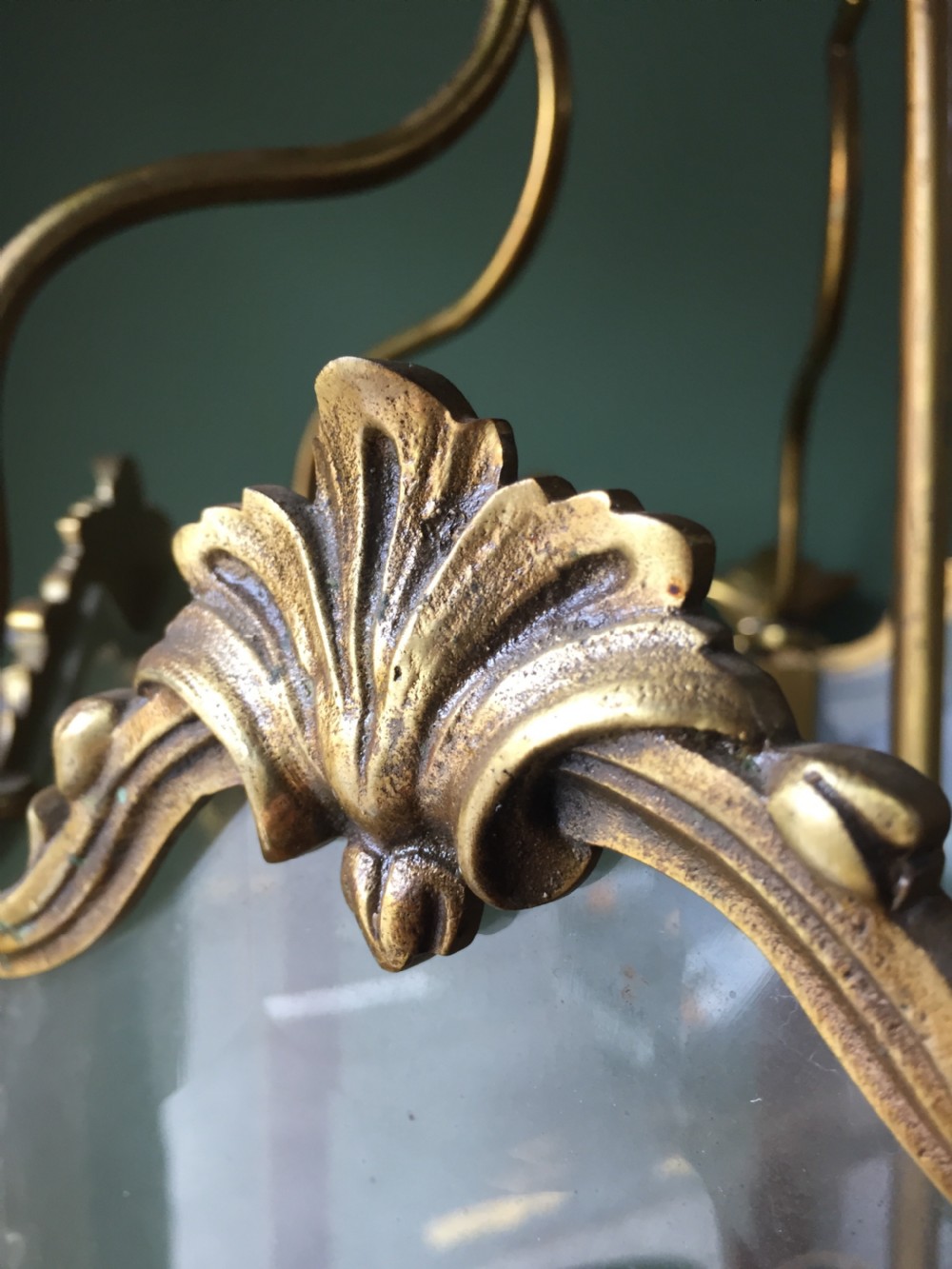 A late nineteenth-century French gilded brass hexagonal hall lantern featuring curved glass panels and acanthus leaf ornamentation. View XIV