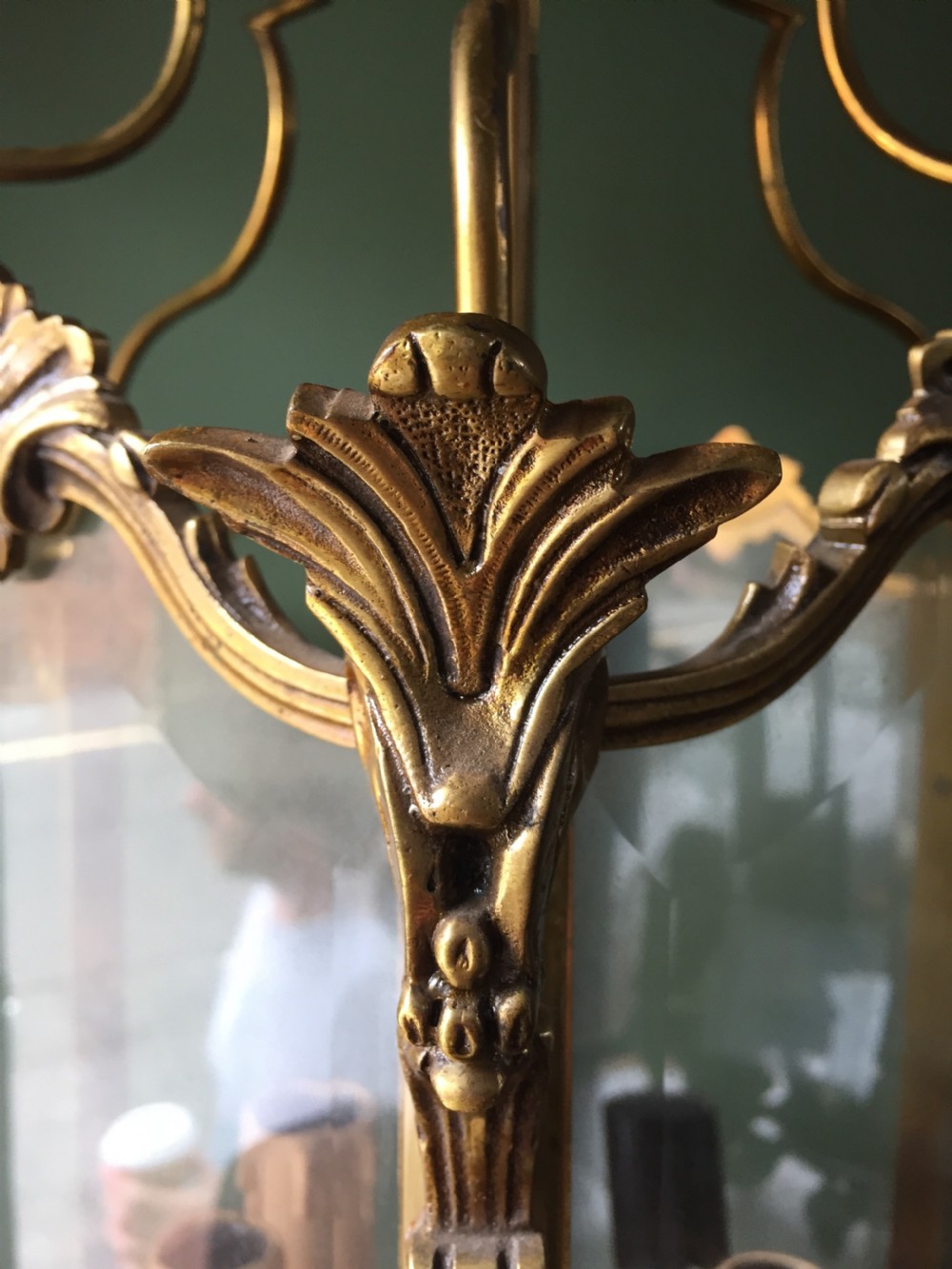 A late nineteenth-century French gilded brass hexagonal hall lantern featuring curved glass panels and acanthus leaf ornamentation. View XV