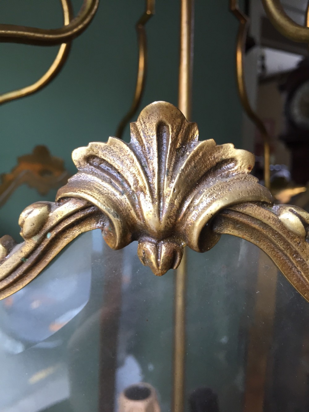 A late nineteenth-century French gilded brass hexagonal hall lantern featuring curved glass panels and acanthus leaf ornamentation. View XVI