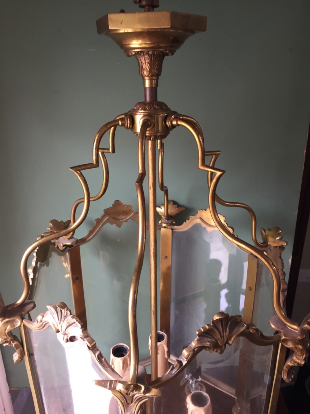 A late nineteenth-century French gilded brass hexagonal hall lantern featuring curved glass panels and acanthus leaf ornamentation. View XVII
