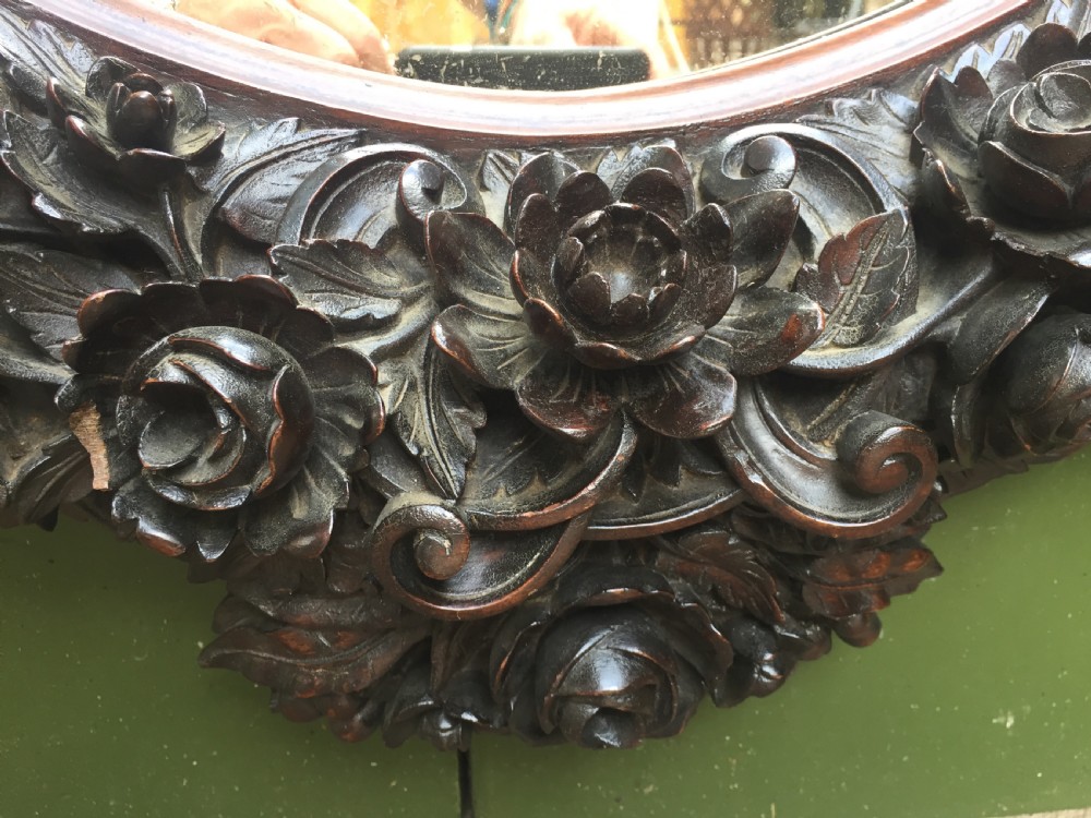 Exceptional mid C19th Indo-Portuguese carved rosewood or padauk framed oval mirror. View X