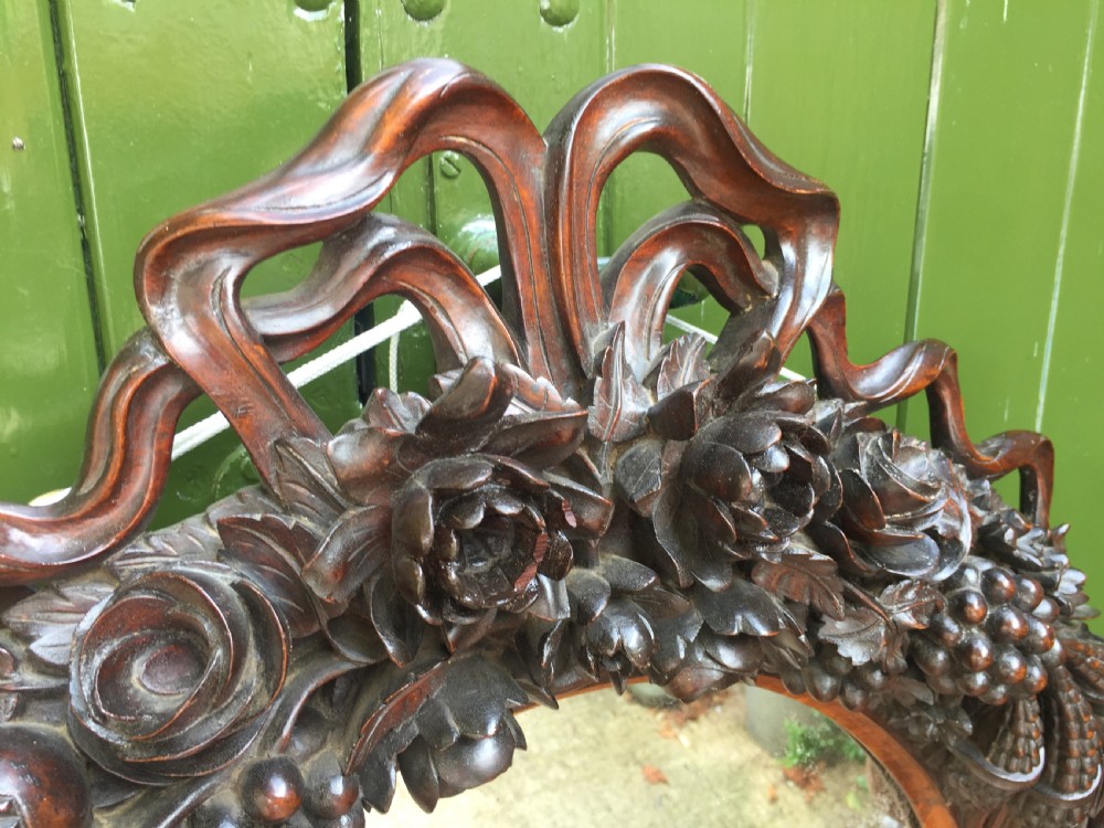 Exceptional mid C19th Indo-Portuguese carved rosewood or padauk framed oval mirror. View XVIII