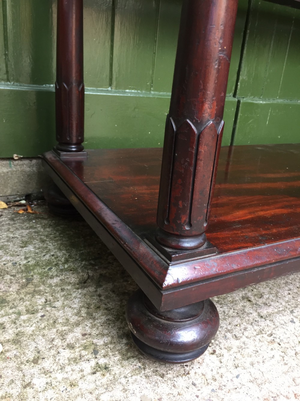 A George IV mahogany three-tier buffet featuring a carved scroll upstand, turned finials, column supports, and a glass-inset middle shelf. View VIII