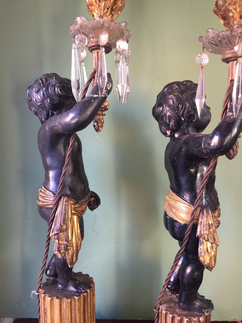 Pair of early C19th Italian carved wood amorini or cherubs modelled as lamps raised on truncated fluted column bases. View VII