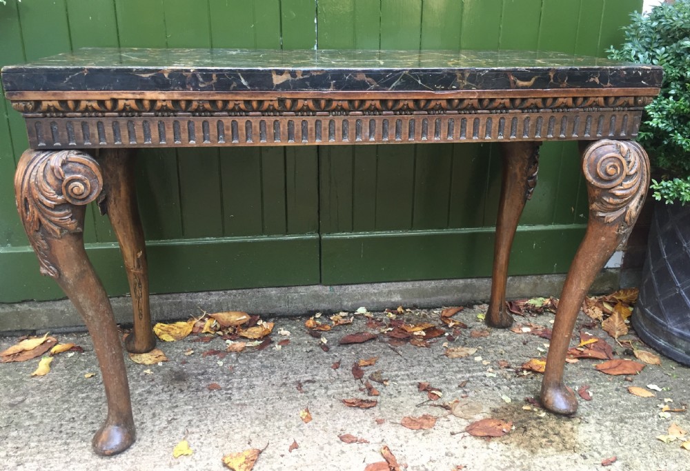 Interesting and decorative C18th George II period style carved and polished pine pier table with a faux marble slab top.