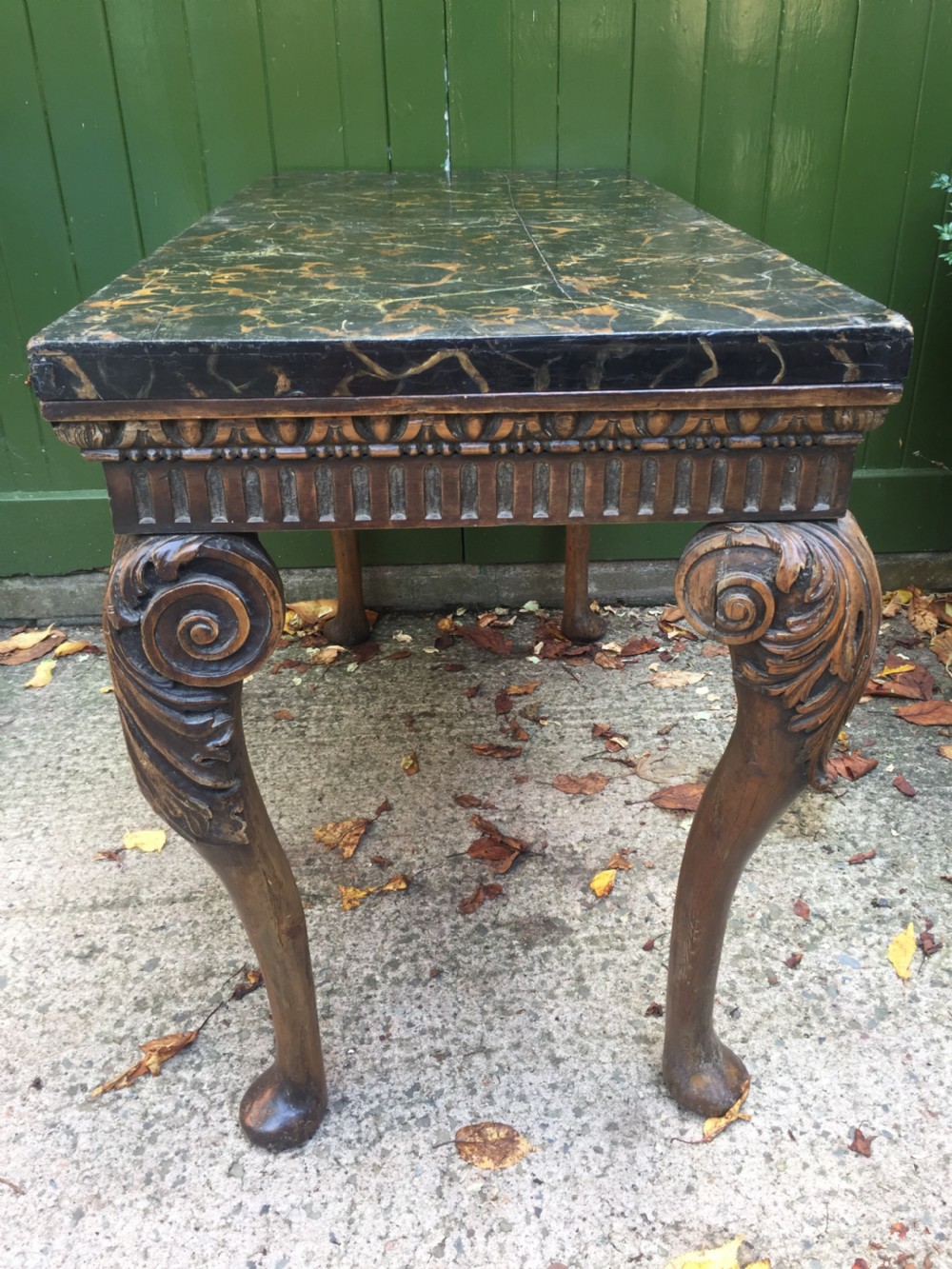 Interesting and decorative C18th George II period style carved and polished pine pier table with a faux marble slab top. View XIV