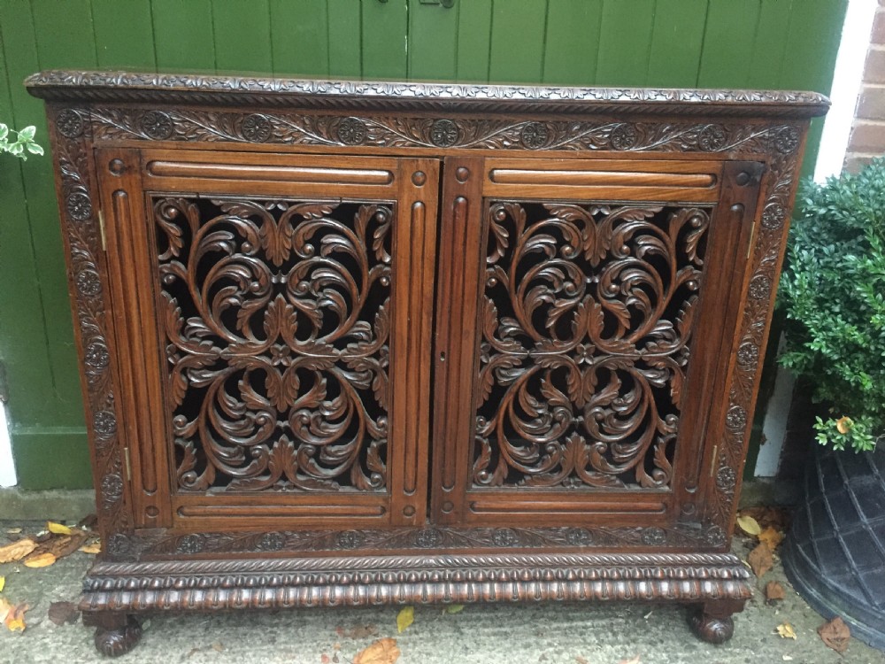 Mid C19th Anglo-Indian carved padauk or rosewood dwarf bookcase or side cabinet .