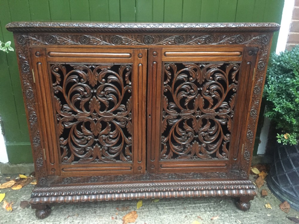 Mid C19th Anglo-Indian carved padauk or rosewood dwarf bookcase or side cabinet . View II