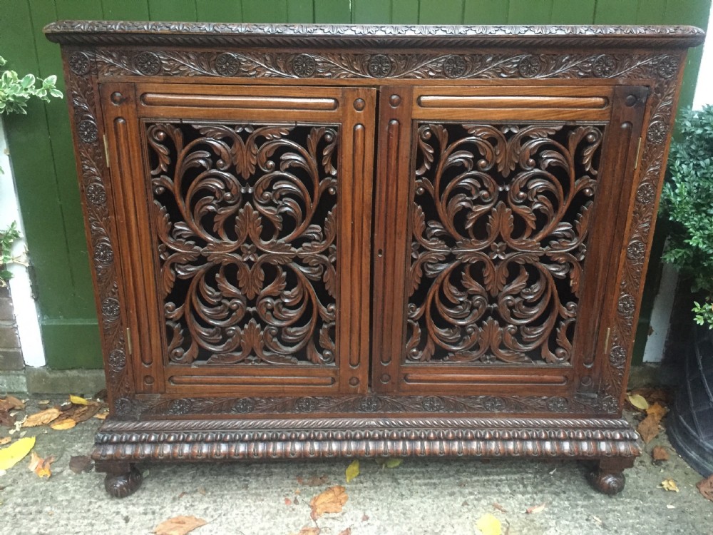 Mid C19th Anglo-Indian carved padauk or rosewood dwarf bookcase or side cabinet . View VI