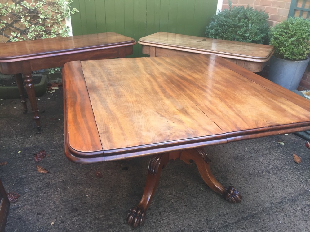 An early nineteenth-century George IV Irish mahogany extending dining table featuring a central pedestal base and turned support legs with brass castors. View IX