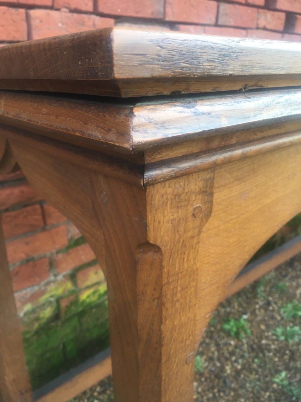 A rectangular oak serving table featuring a moulded top, shaped arched apron, square legs, and perimeter stretchers. View VI