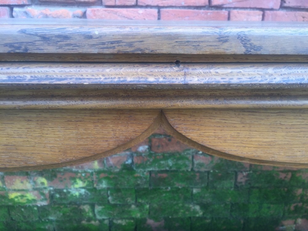 A rectangular oak serving table featuring a moulded top, shaped arched apron, square legs, and perimeter stretchers. View VIII