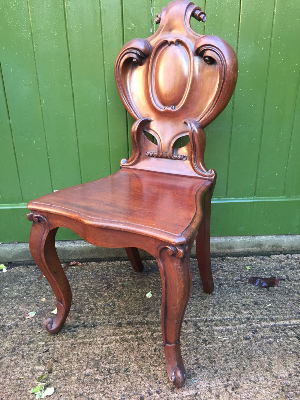 A high quality Victorian mahogany hall chair of particularly bold and flamboyant design  View II