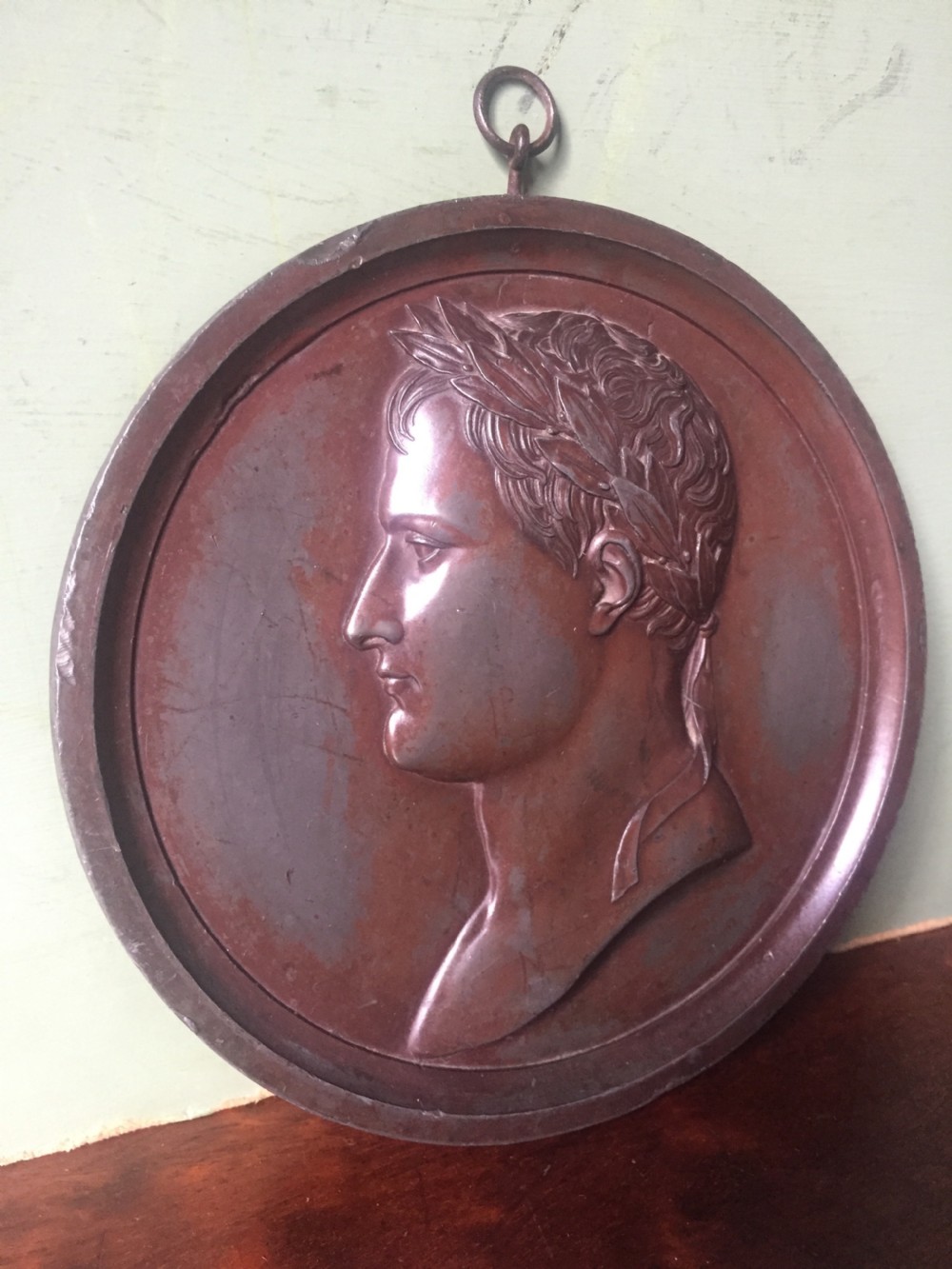 A pair of circular turned mahogany frames enclosing dark bronzed relief profile portraits of Napoleon and Marie-Louise under glass. View II