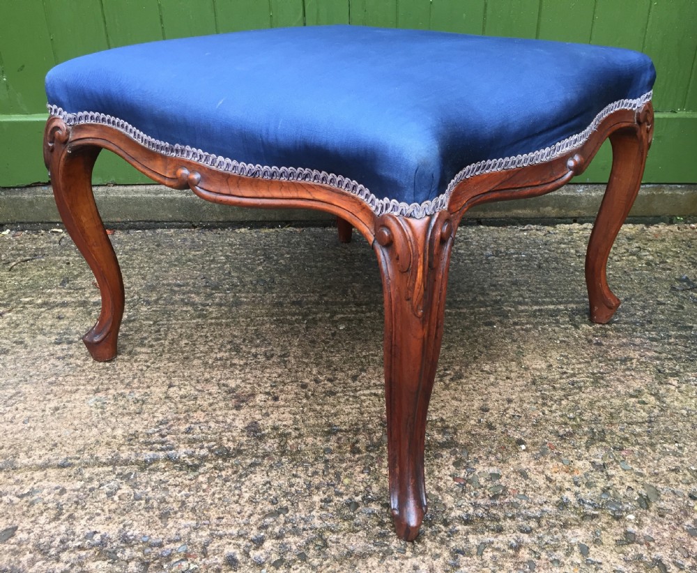 A large mid-nineteenth-century square Victorian stool featuring carved walnut cabriole legs and a blue upholstered top trimmed with gimp braid. View II