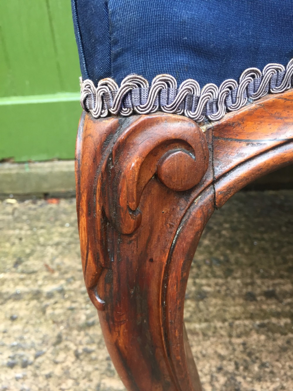 A large mid-nineteenth-century square Victorian stool featuring carved walnut cabriole legs and a blue upholstered top trimmed with gimp braid. View VIII