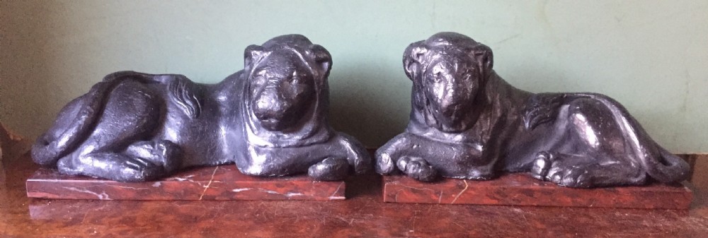 Pair of early C19th 'Grand Tour' souvenir patinated cast-lead lions mounted upon rouge griotte marble plinth bases , copies of the Egyptian lions from The Vatican, Rome.