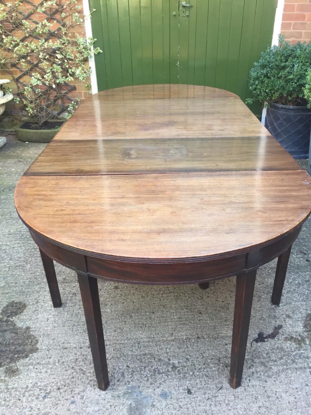 Highly versatile C18th George III period mahogany D-ended dining table with various configuration options in 'as found' country-house condition. View III