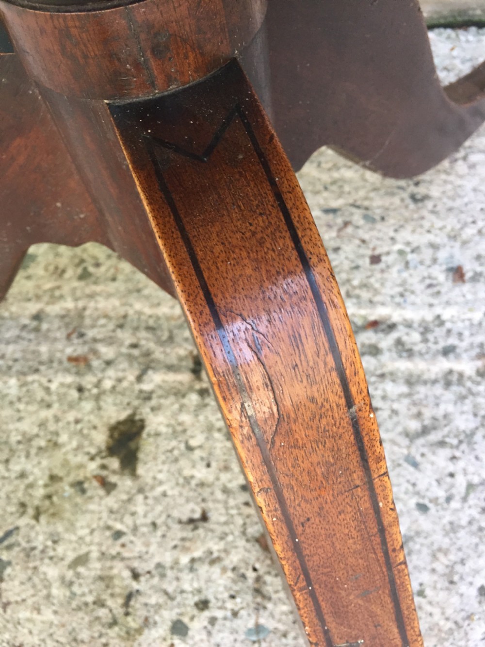 A late 18th-century George III mahogany three-tier circular dumb waiter featuring folding drop-leaf surfaces and a tripod base on castors. View XVIII