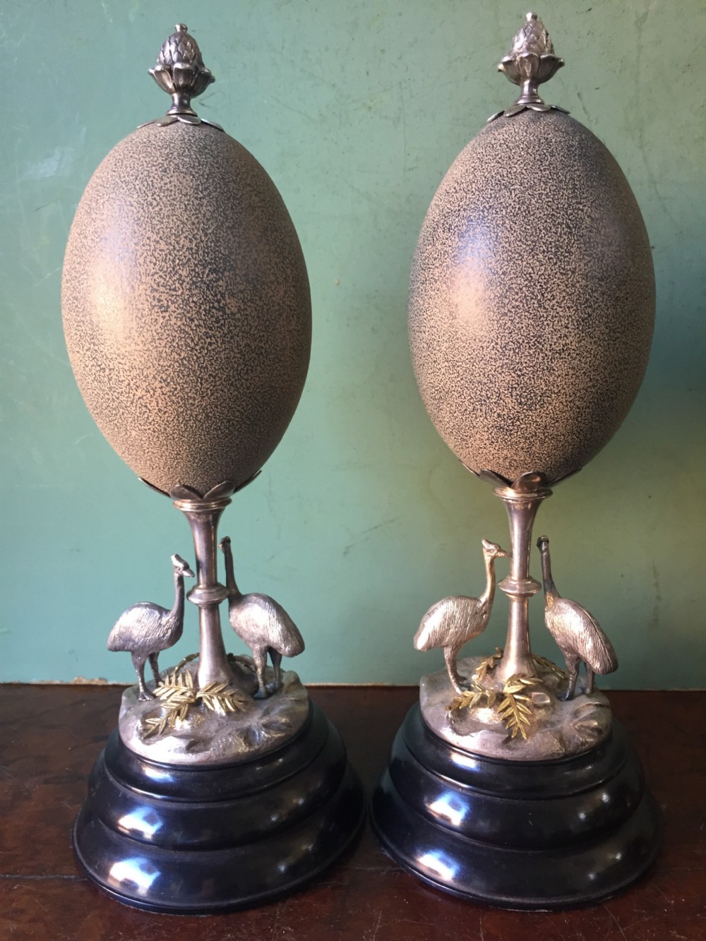 Of Australian interest: Pair of late C19th silver-plated mounted Emu eggs on ebonised socle bases. View II