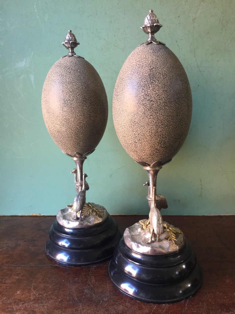Of Australian interest: Pair of late C19th silver-plated mounted Emu eggs on ebonised socle bases. View III