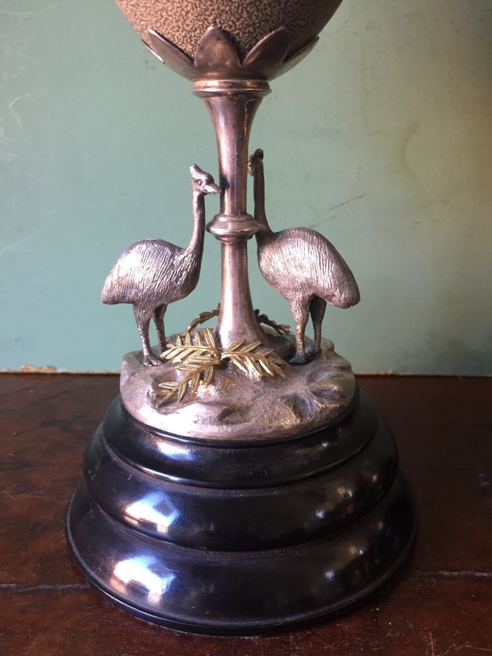 Of Australian interest: Pair of late C19th silver-plated mounted Emu eggs on ebonised socle bases. View X