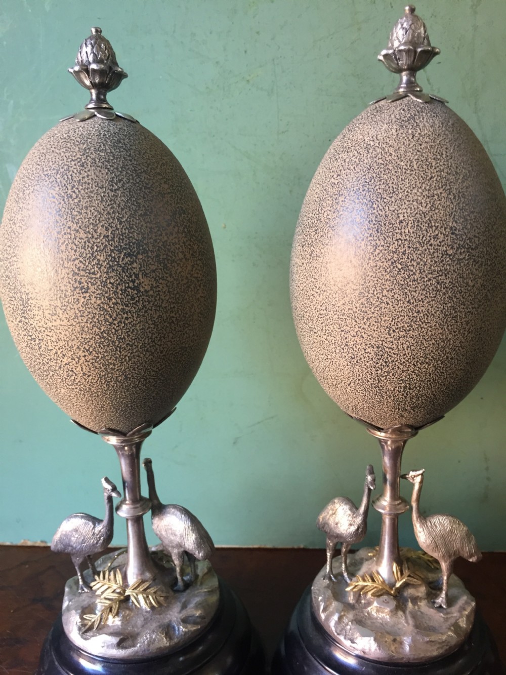 Of Australian interest: Pair of late C19th silver-plated mounted Emu eggs on ebonised socle bases. View XII