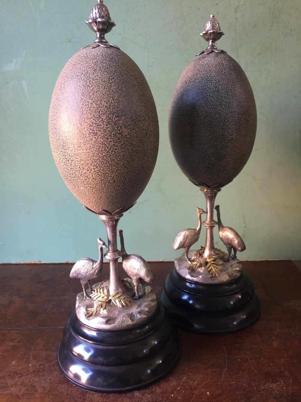 Of Australian interest: Pair of late C19th silver-plated mounted Emu eggs on ebonised socle bases. View XIII