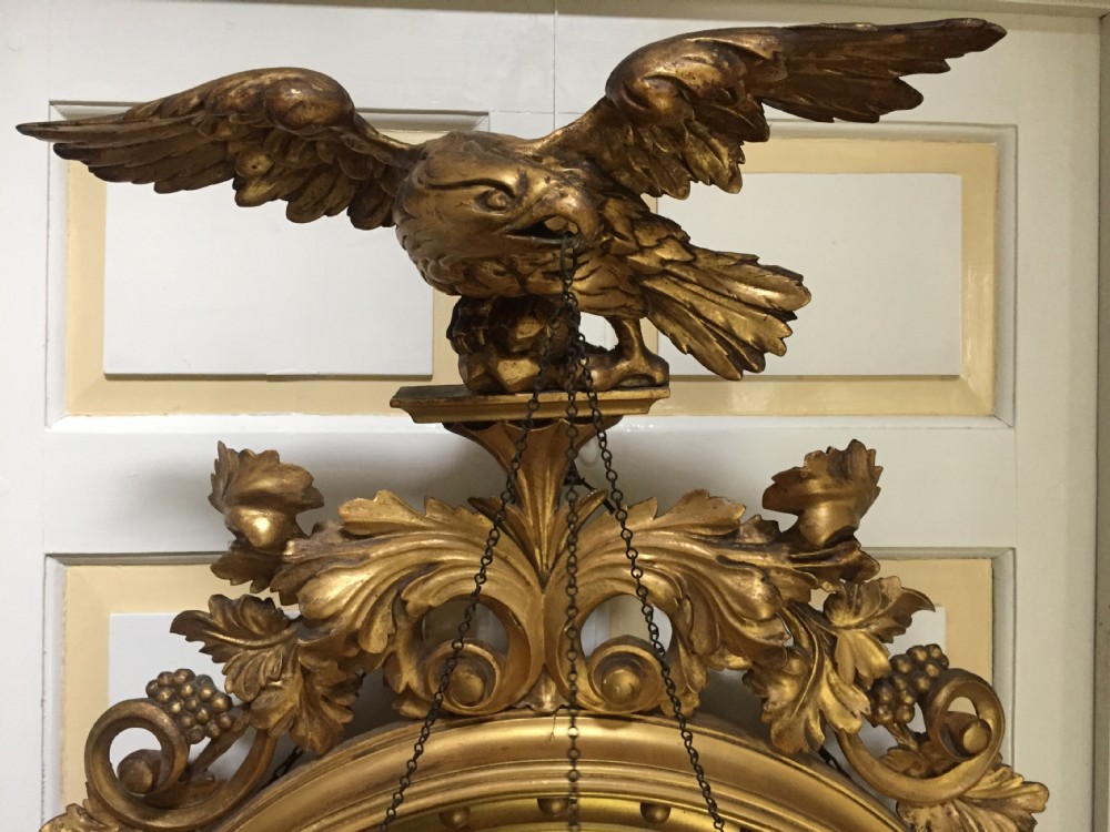 Large and impressive Regency period carved gilt-wood frame girandole convex mirror with eagle surmount. View V