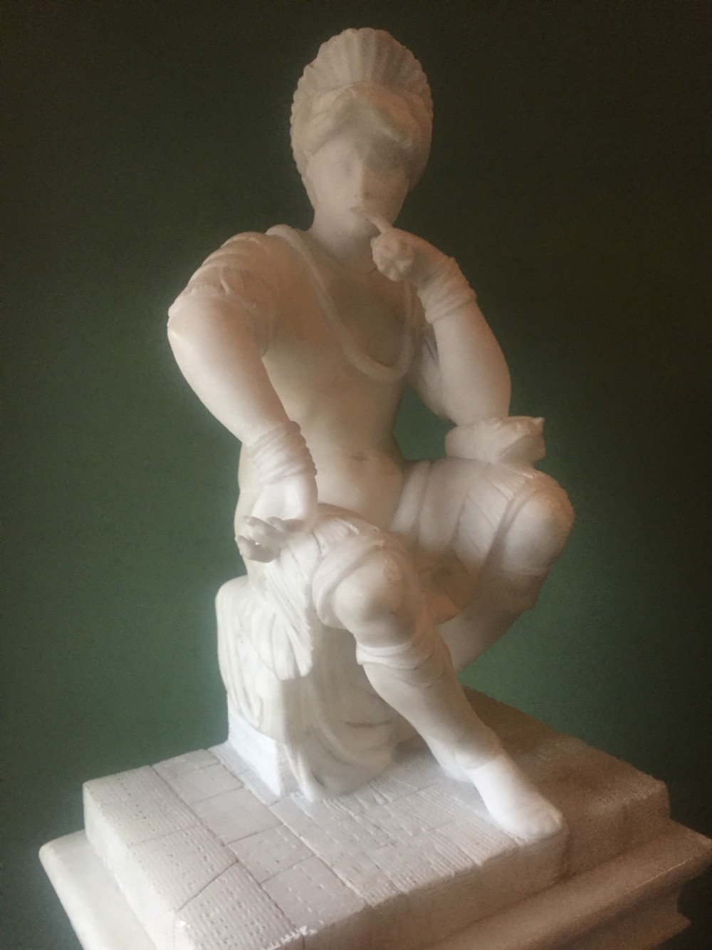 A nineteenth-century carved white alabaster mantel clock featuring a seated classical figure on a pedestal base enclosed under a tall glass dome. View VII