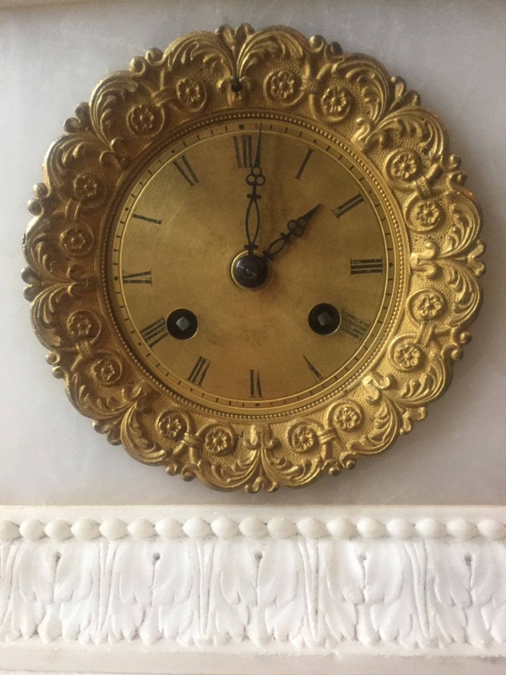 A nineteenth-century carved white alabaster mantel clock featuring a seated classical figure on a pedestal base enclosed under a tall glass dome. View VIII