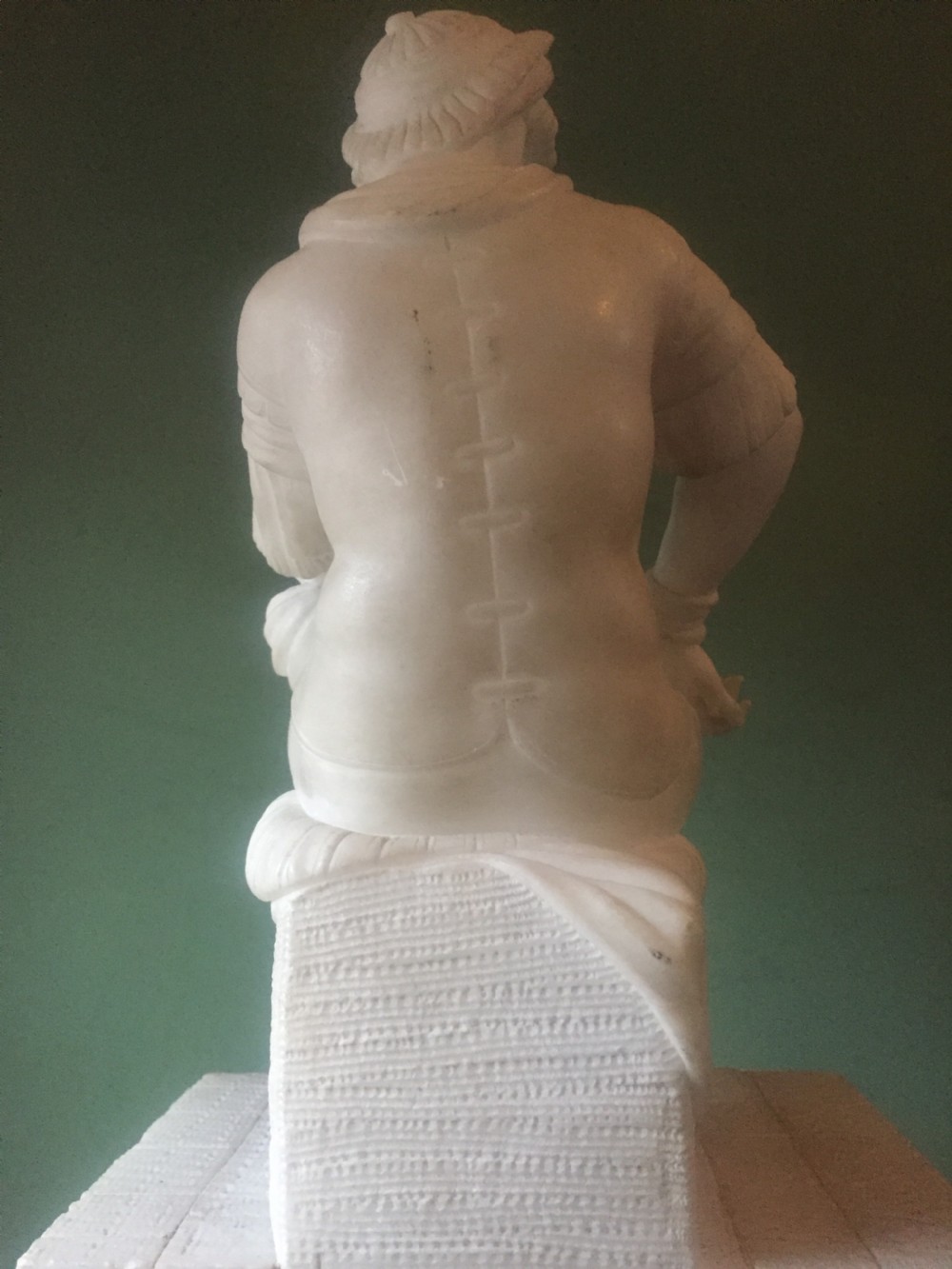 A nineteenth-century carved white alabaster mantel clock featuring a seated classical figure on a pedestal base enclosed under a tall glass dome. View XIII