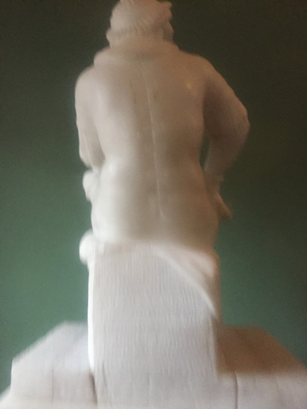 A nineteenth-century carved white alabaster mantel clock featuring a seated classical figure on a pedestal base enclosed under a tall glass dome. View XIV