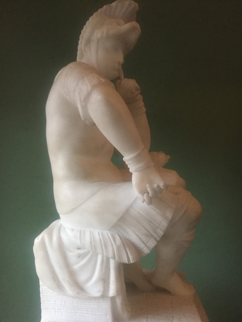 A nineteenth-century carved white alabaster mantel clock featuring a seated classical figure on a pedestal base enclosed under a tall glass dome. View XVIII