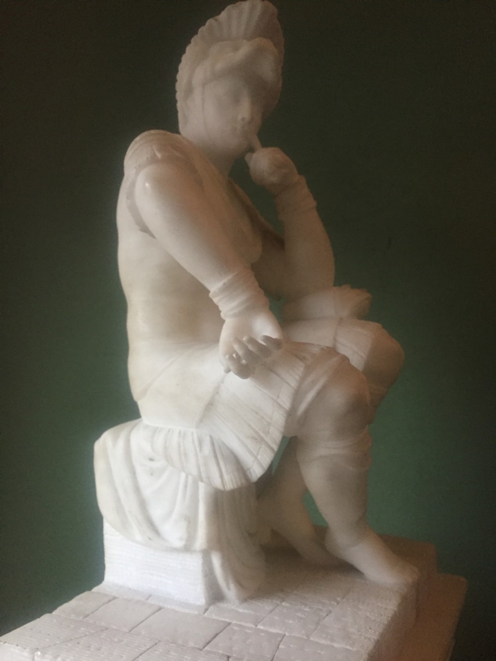 A nineteenth-century carved white alabaster mantel clock featuring a seated classical figure on a pedestal base enclosed under a tall glass dome. View XXI