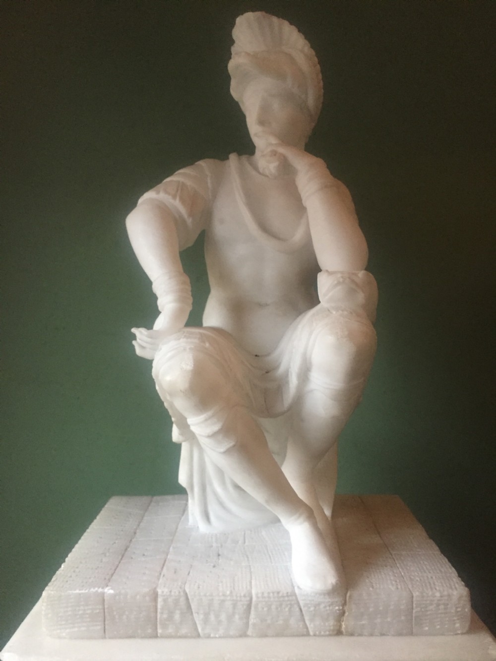 A nineteenth-century carved white alabaster mantel clock featuring a seated classical figure on a pedestal base enclosed under a tall glass dome. View XXIII