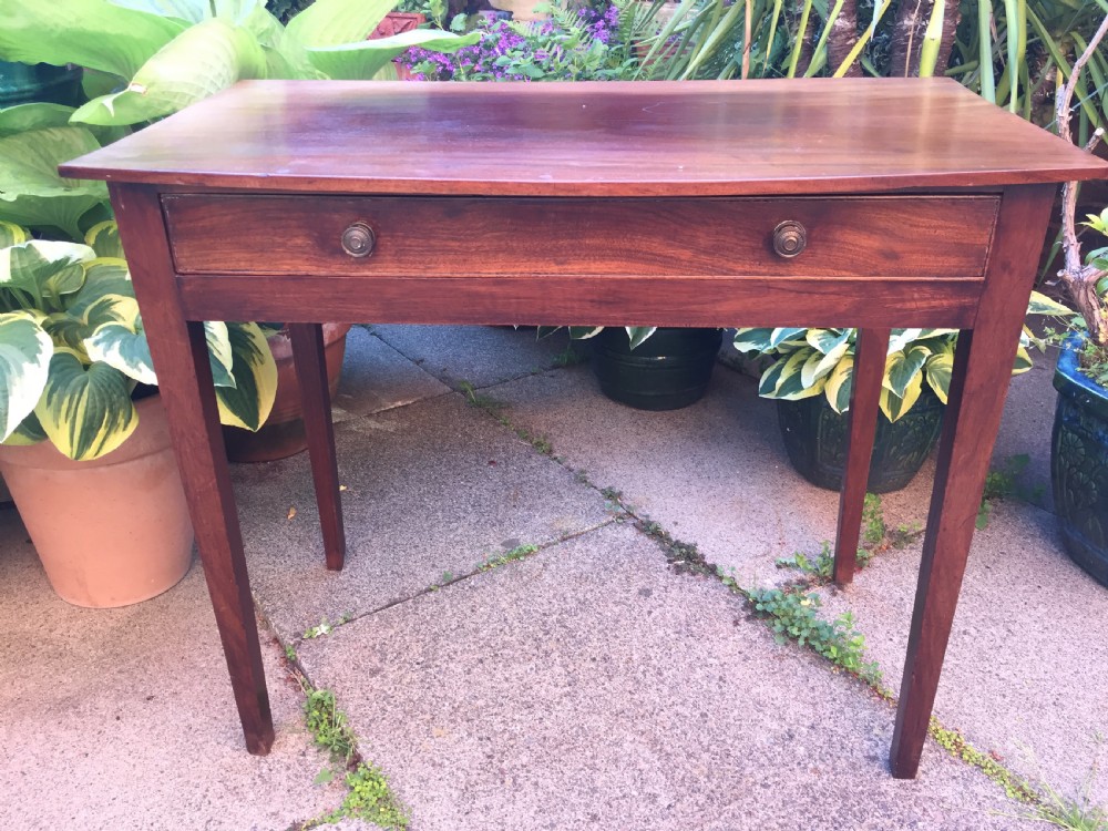 A late eighteenth-century George III mahogany side table featuring a single frieze drawer with brass handles and straight tapered legs. View II