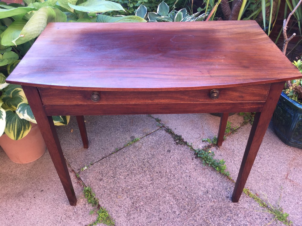 A late eighteenth-century George III mahogany side table featuring a single frieze drawer with brass handles and straight tapered legs. View III