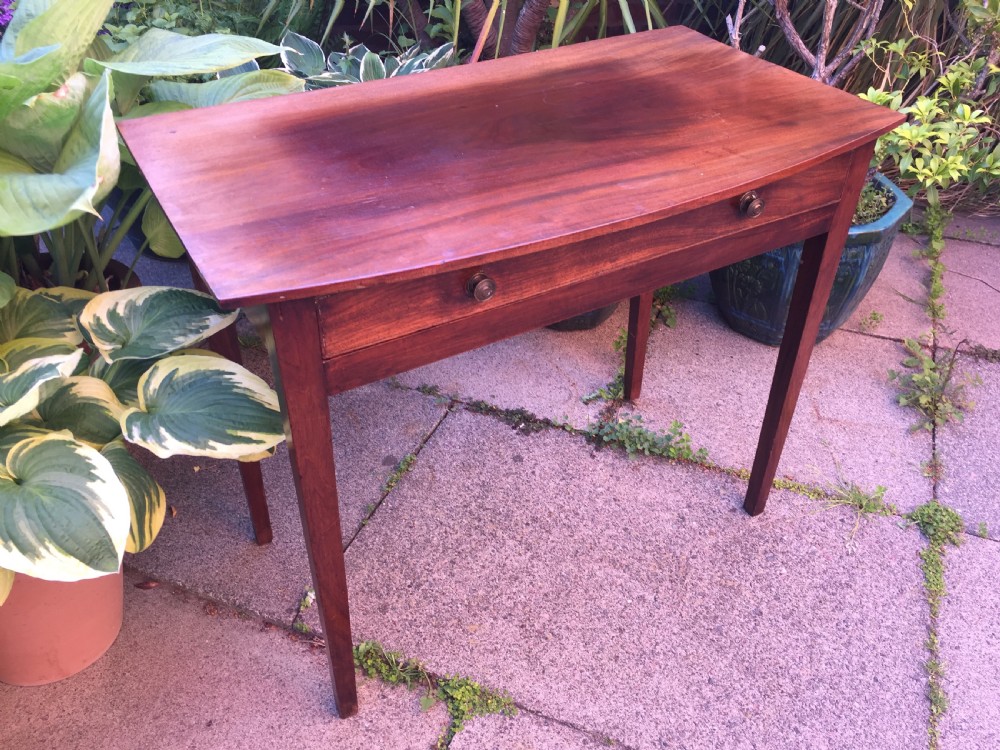 A late eighteenth-century George III mahogany side table featuring a single frieze drawer with brass handles and straight tapered legs. View V