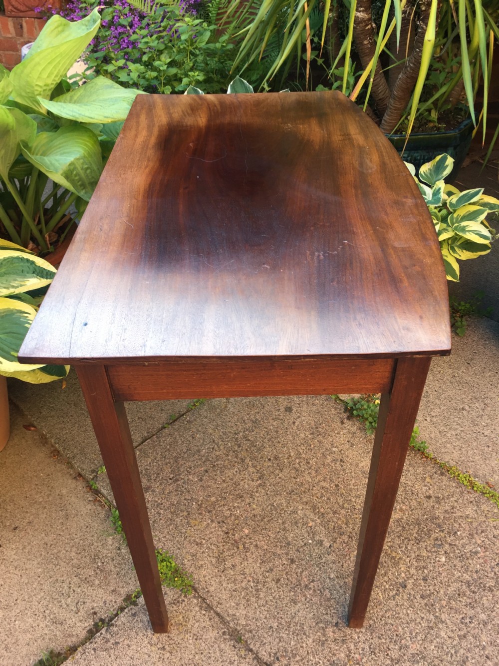 A late eighteenth-century George III mahogany side table featuring a single frieze drawer with brass handles and straight tapered legs. View VI