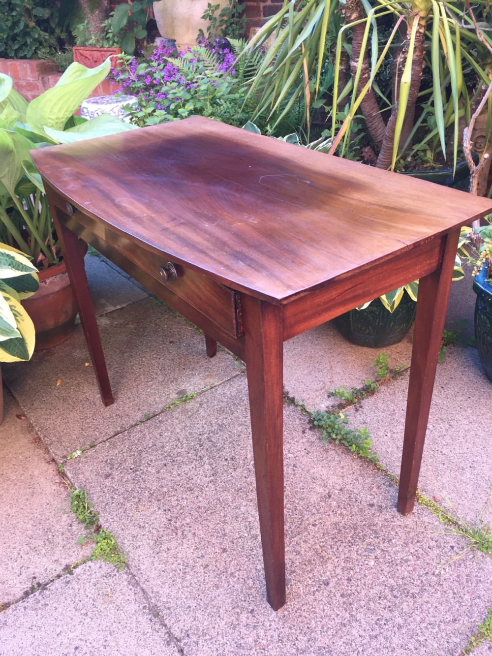 A late eighteenth-century George III mahogany side table featuring a single frieze drawer with brass handles and straight tapered legs. View VIII