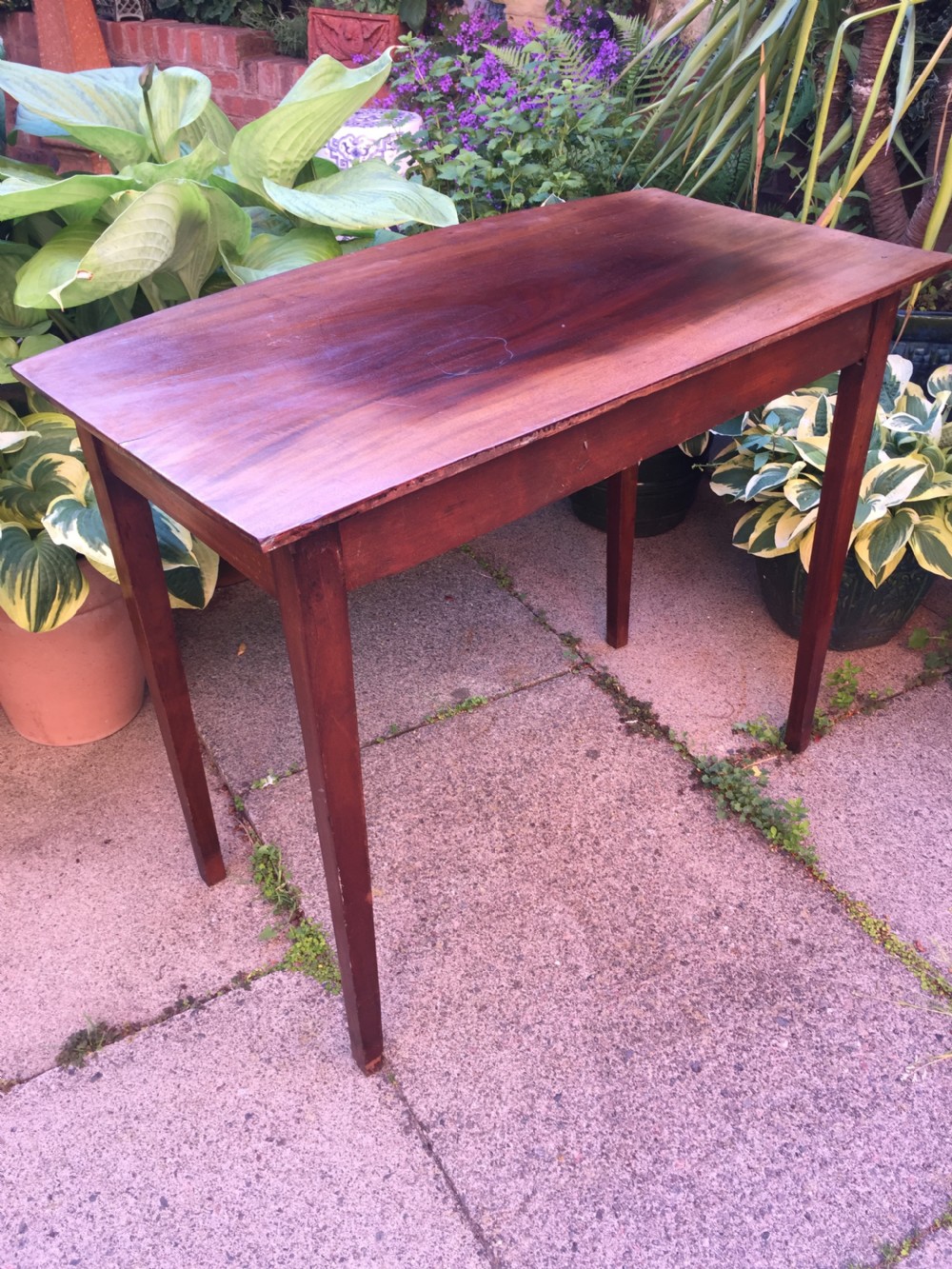 A late eighteenth-century George III mahogany side table featuring a single frieze drawer with brass handles and straight tapered legs. View IX