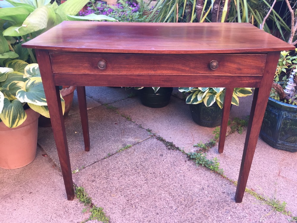 A late eighteenth-century George III mahogany side table featuring a single frieze drawer with brass handles and straight tapered legs. View X