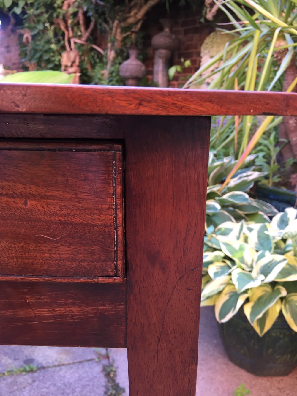 A late eighteenth-century George III mahogany side table featuring a single frieze drawer with brass handles and straight tapered legs. View XII