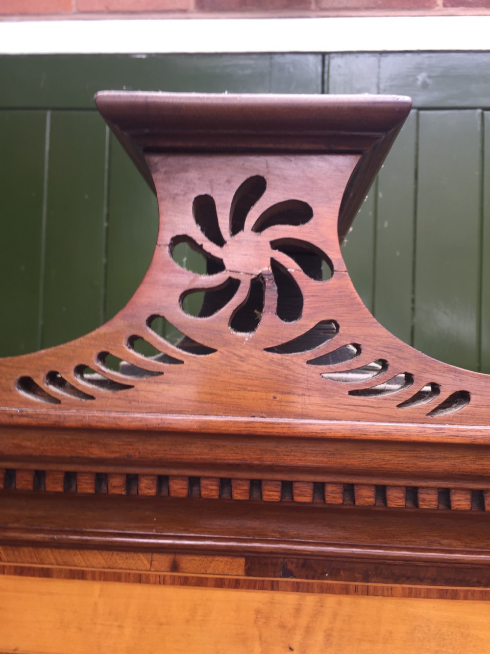 A late 18th-century George III mahogany and satinwood linen press with a swan-neck pediment, oval inlaid cupboard doors, and four lower drawers. View IV